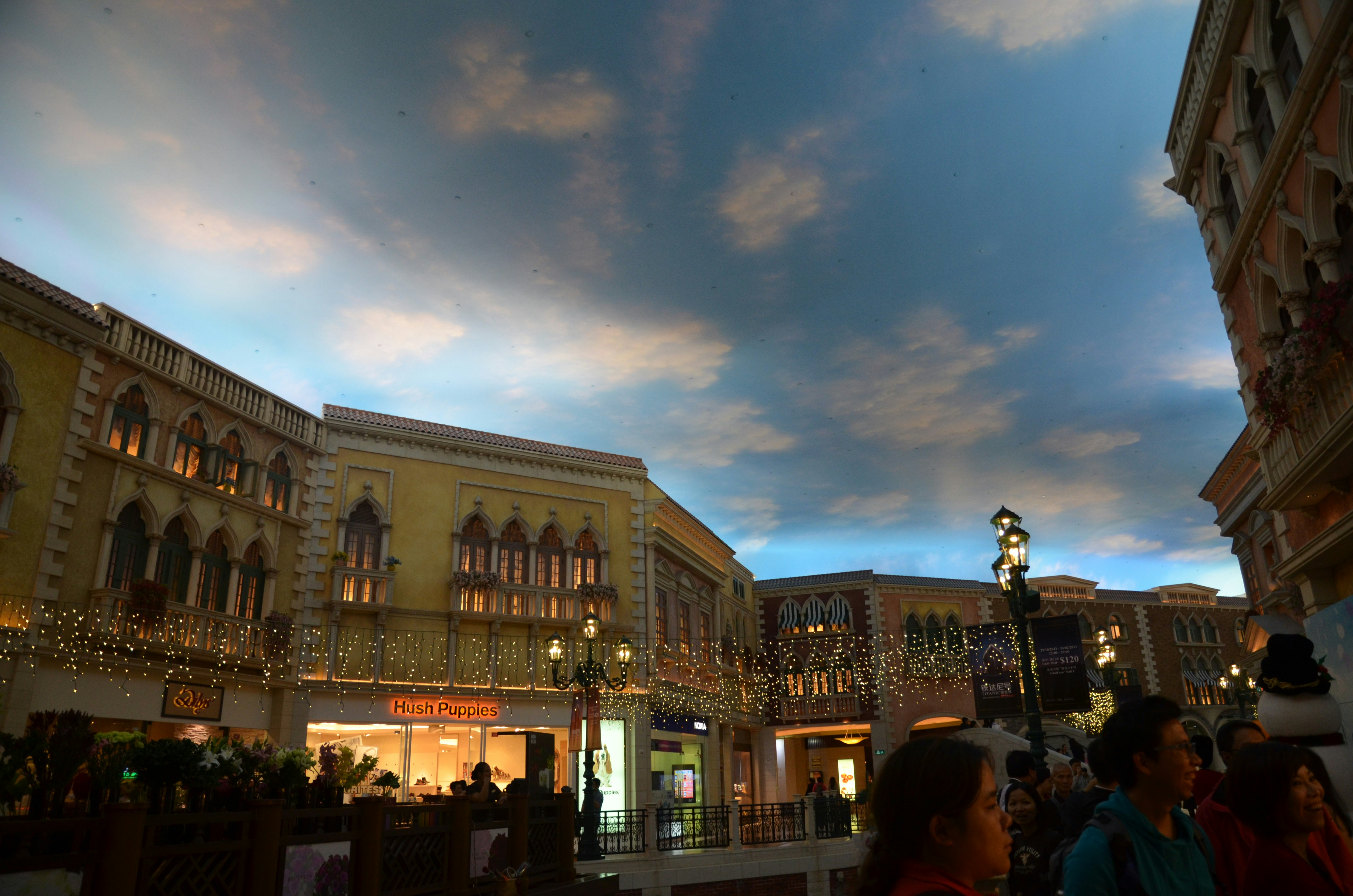 a group of people standing around a shopping mall