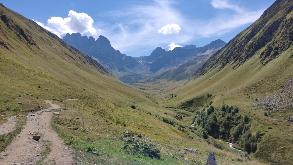 a dirt road in the middle of a valley