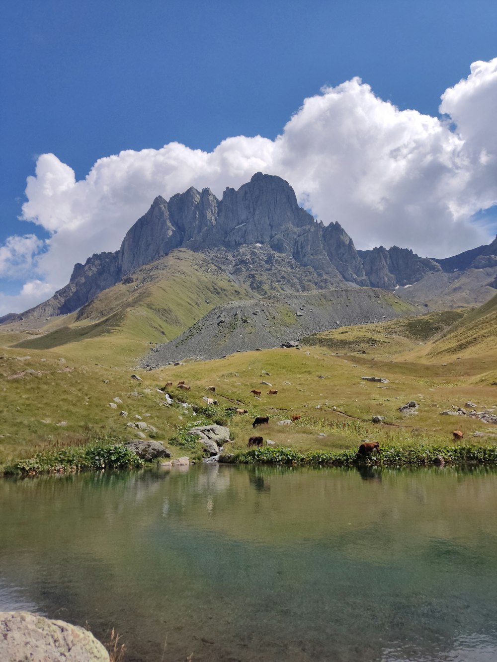 a mountain with a body of water in front of it