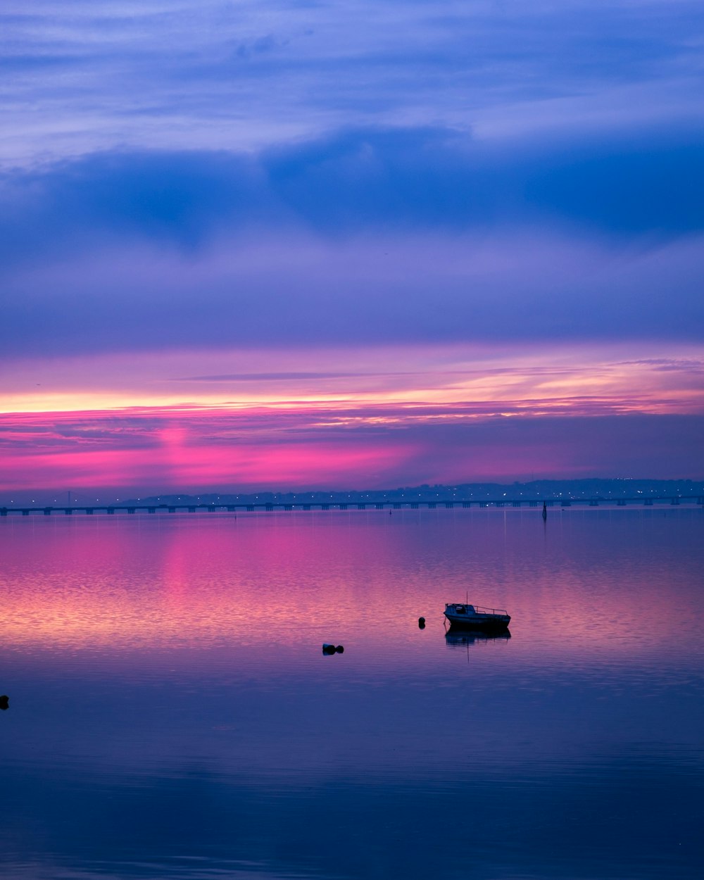 a boat floating on top of a large body of water