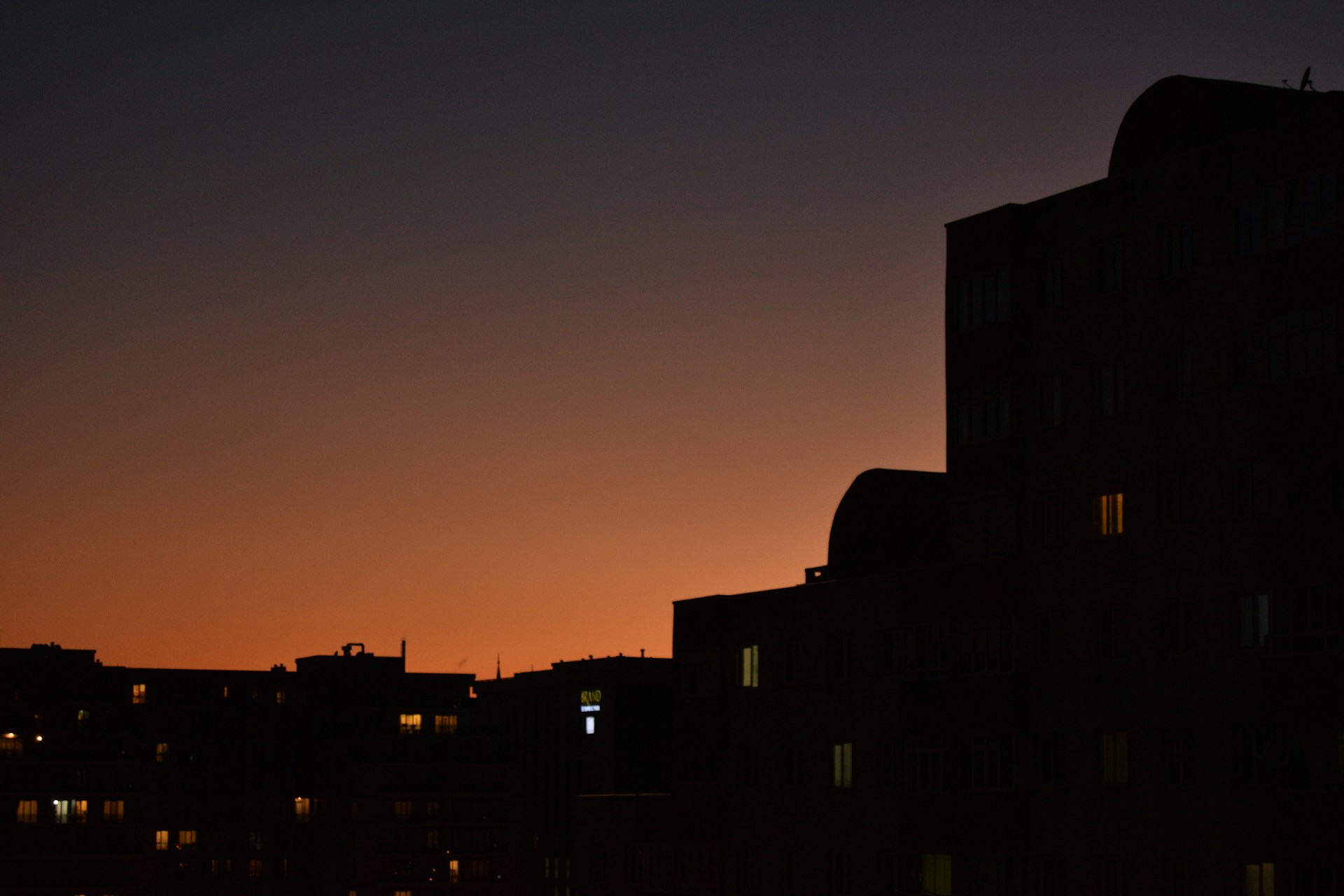 a city skyline at night with buildings lit up
