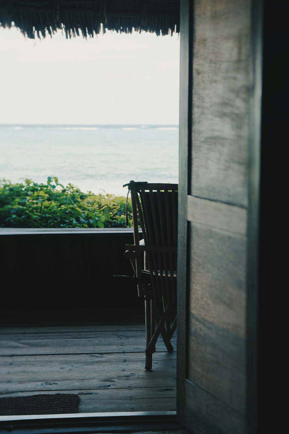 a chair sitting on top of a wooden floor next to a window