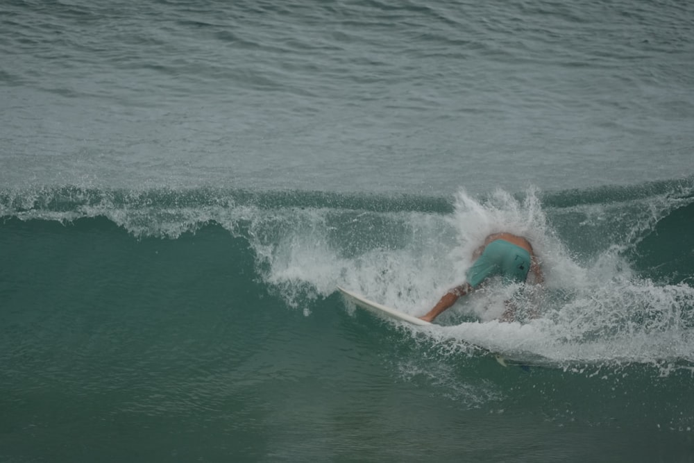 a man riding a wave on top of a surfboard