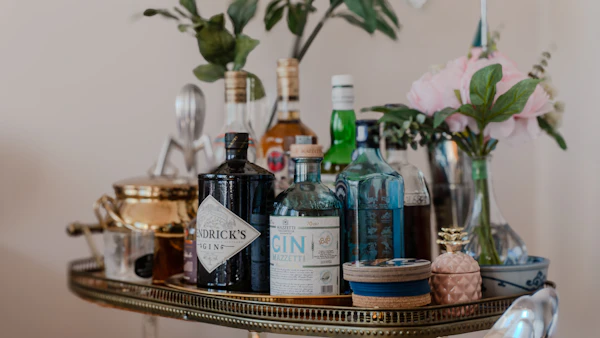 Styled bar cart with bottles and glassware for outdoor entertaining