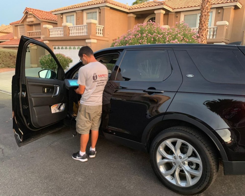 a man opening the door of a black suv