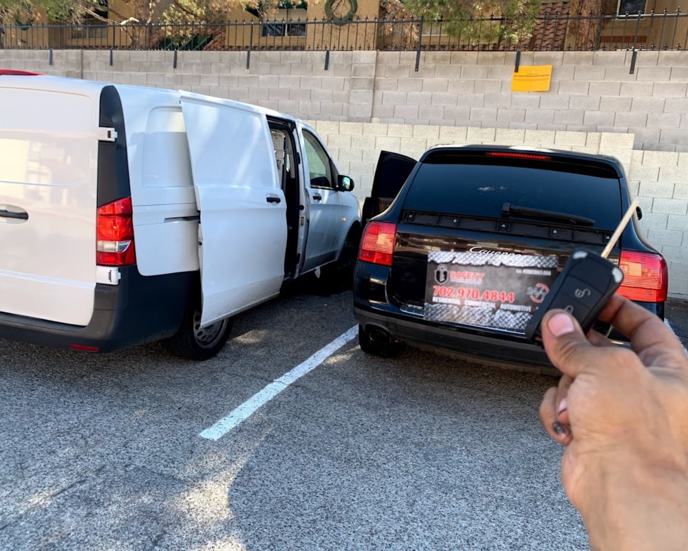 a person holding a remote control next to a van