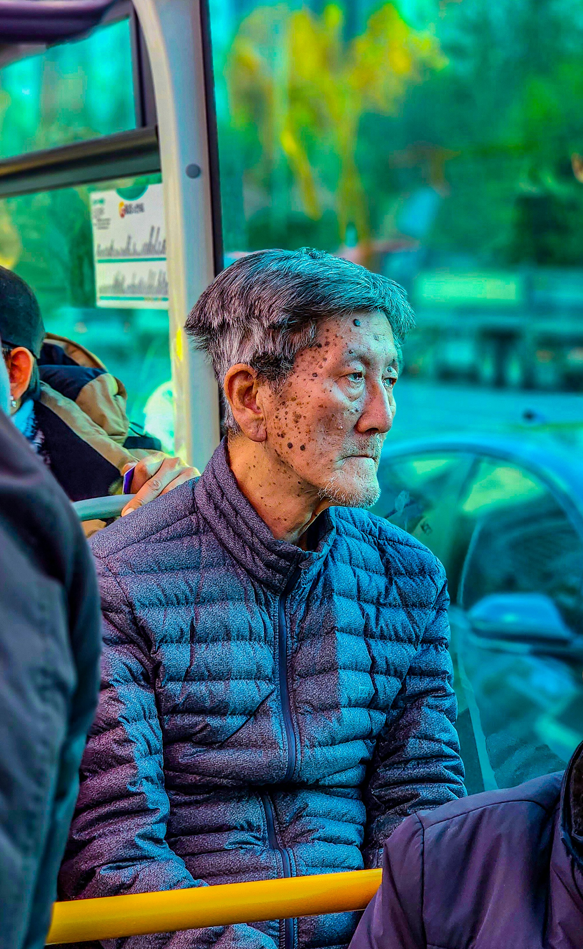 a man covered in mud sitting on a bus