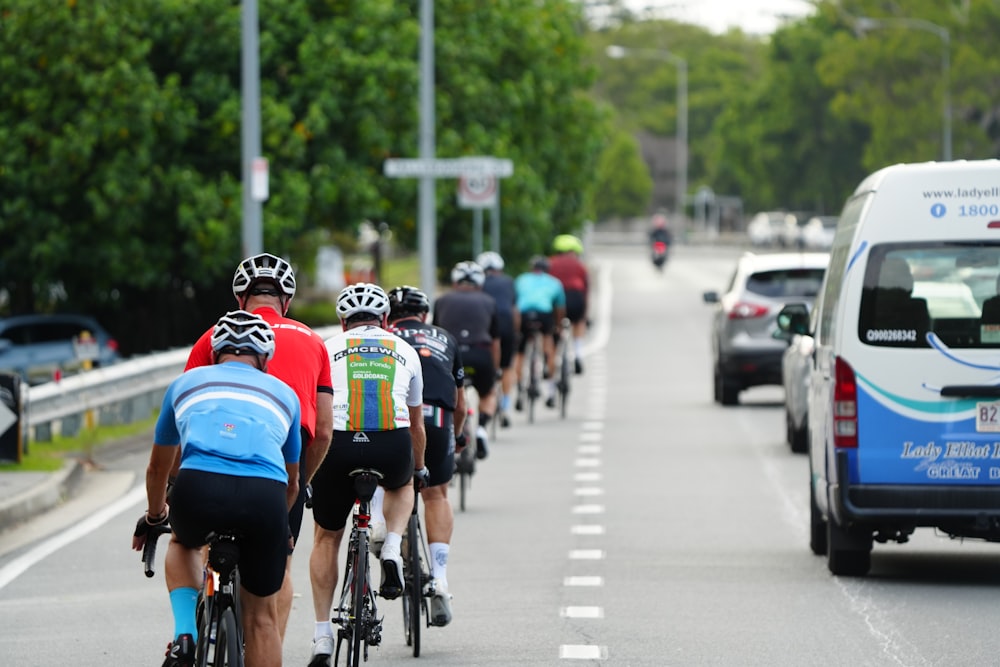 a group of people riding bikes down a street