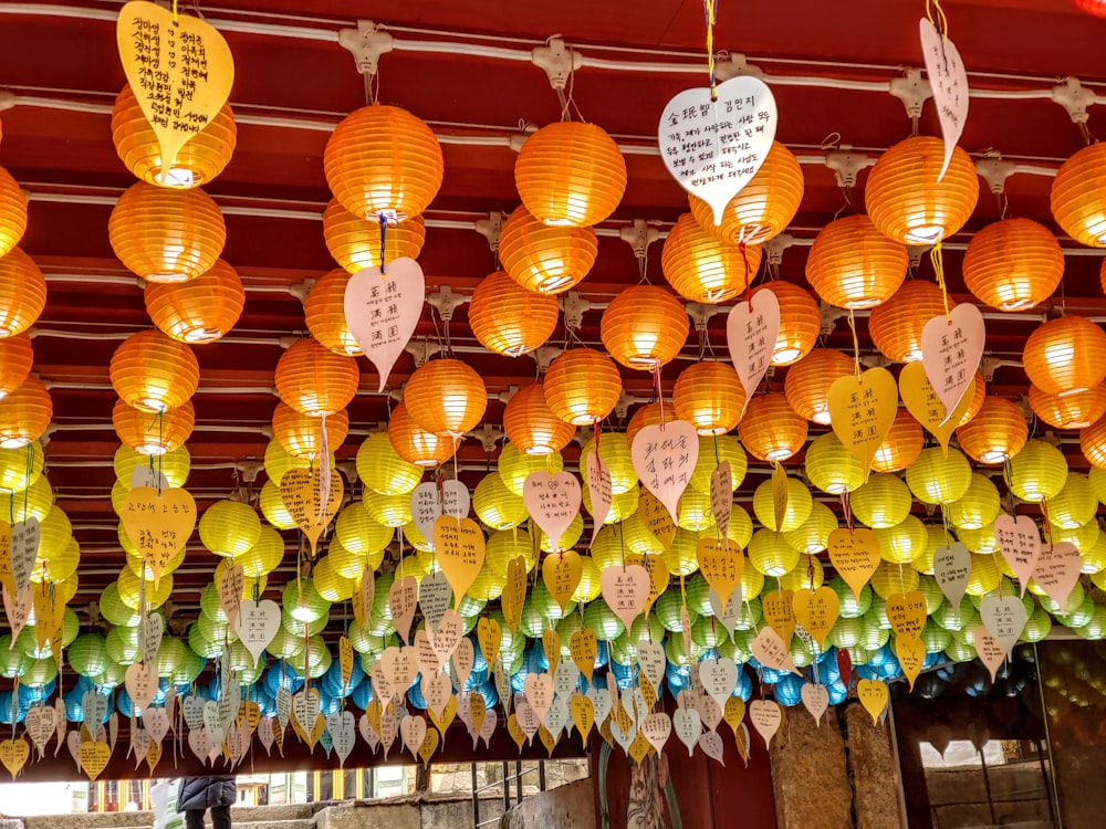 a group of paper lanterns hanging from a ceiling