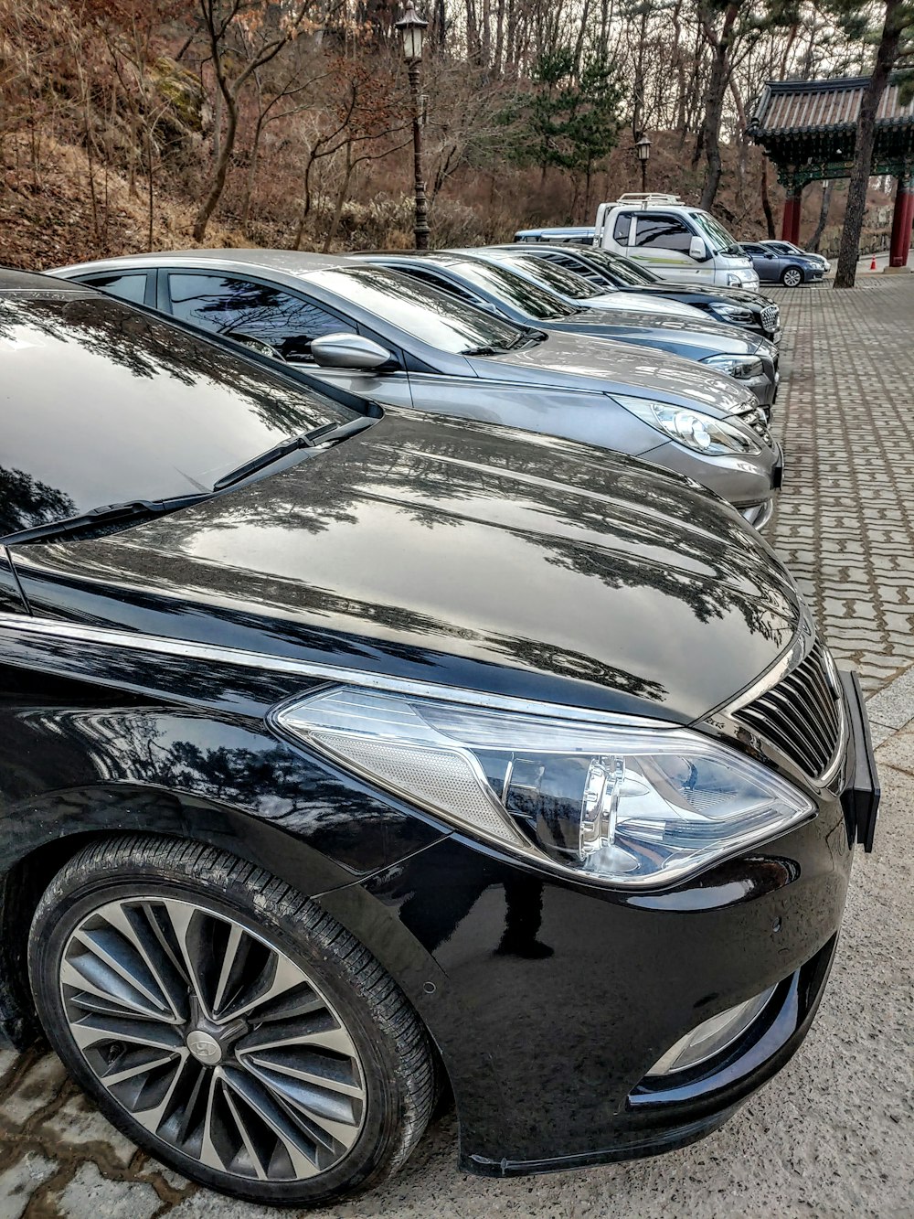 a row of parked cars sitting on the side of a road