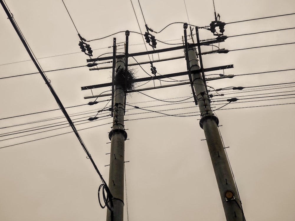 a bunch of power lines and wires against a gray sky