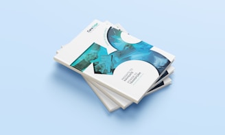 a stack of four business cards on a blue background