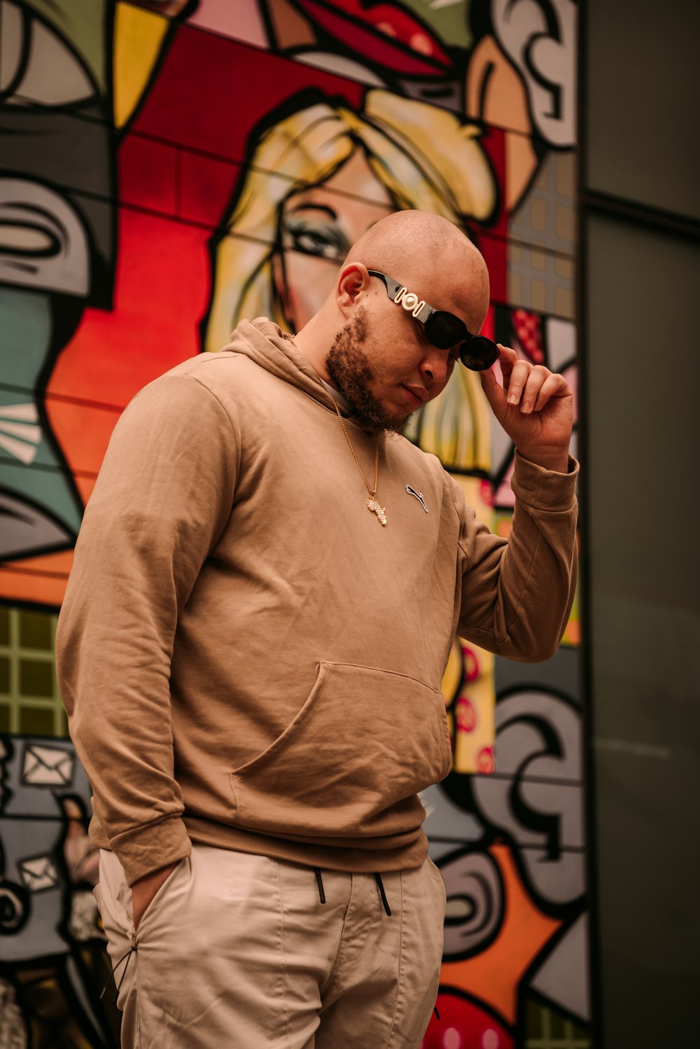 a man standing in front of a colorful wall