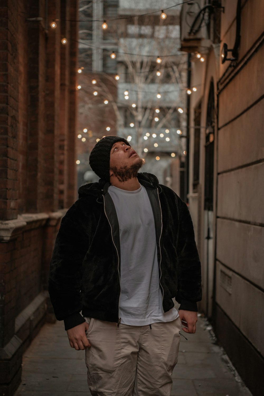 a man walking down a narrow alley way