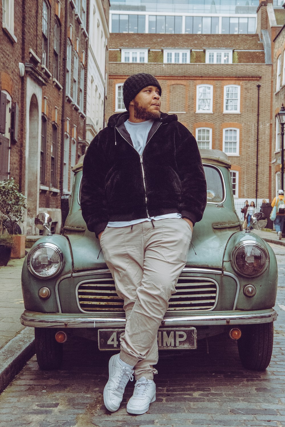 a man sitting on the hood of a car