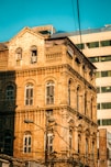 an old building with a clock on the front of it