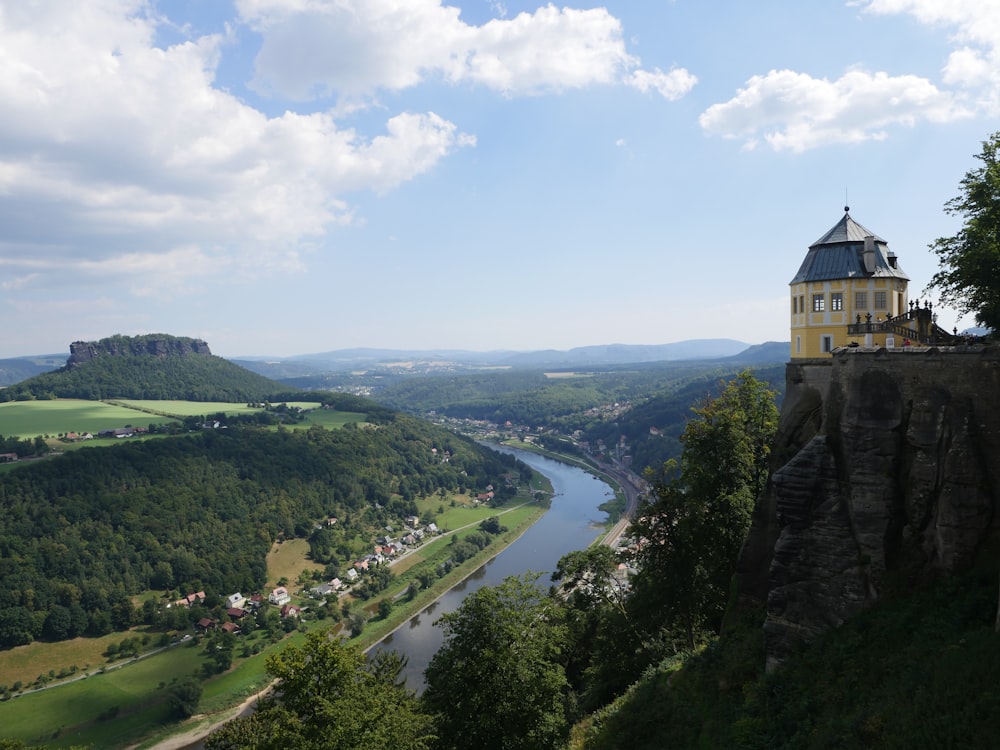 a castle on a cliff overlooking a river
