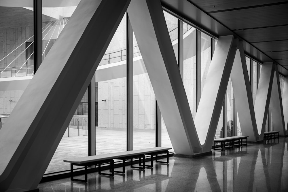 a black and white photo of benches in a building