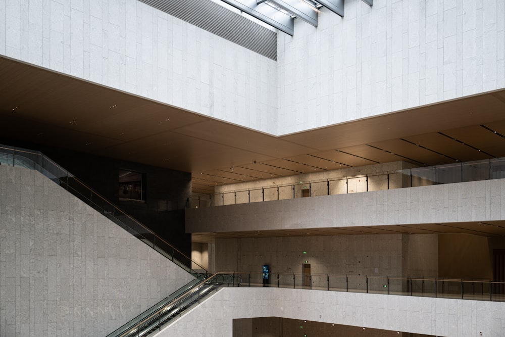 an escalator inside of a building with a skylight