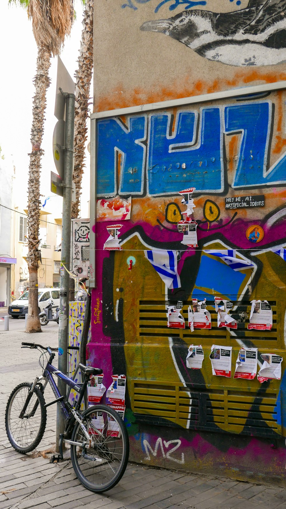 a bike parked next to a wall covered in graffiti