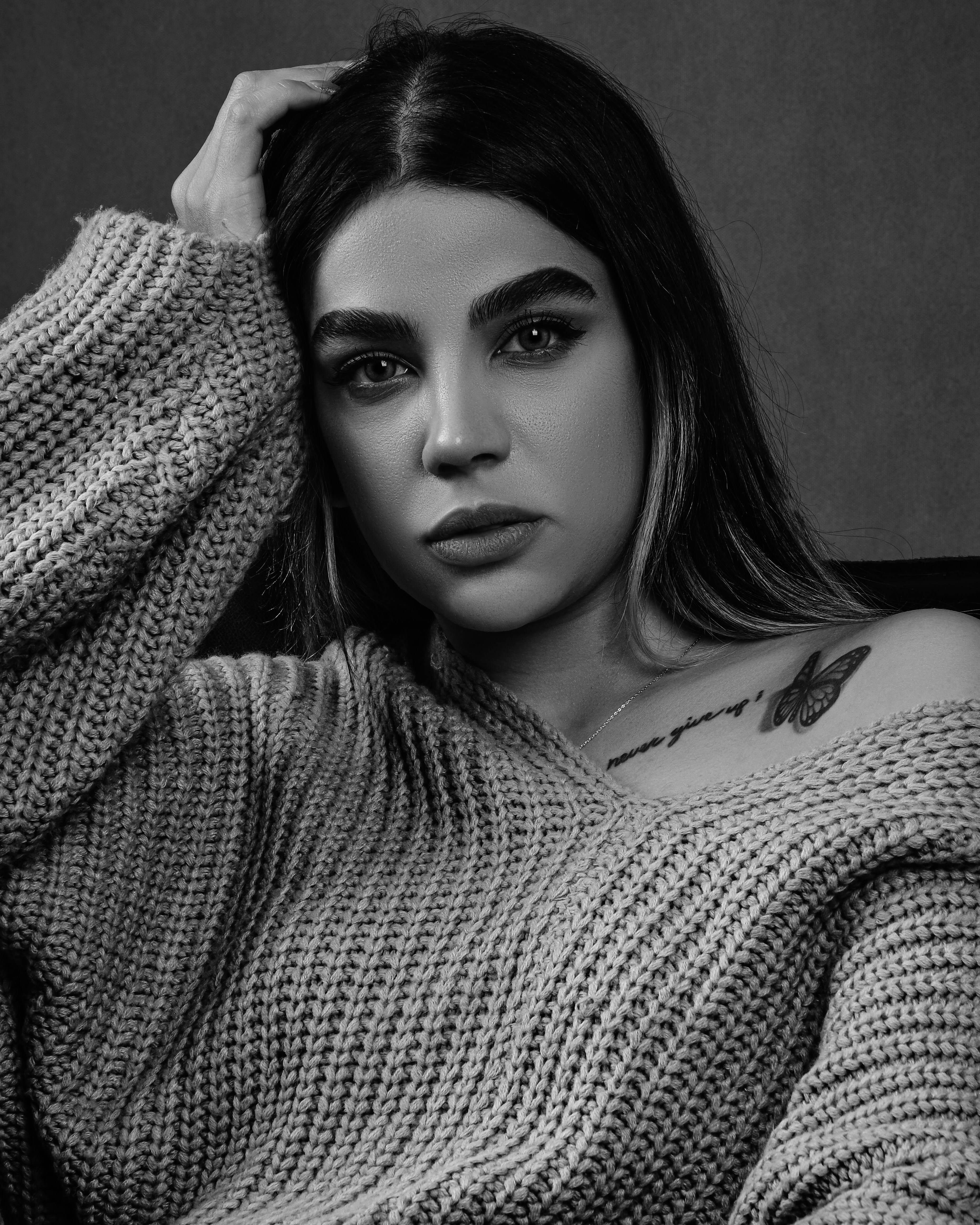 a black and white photo of a woman in a sweater