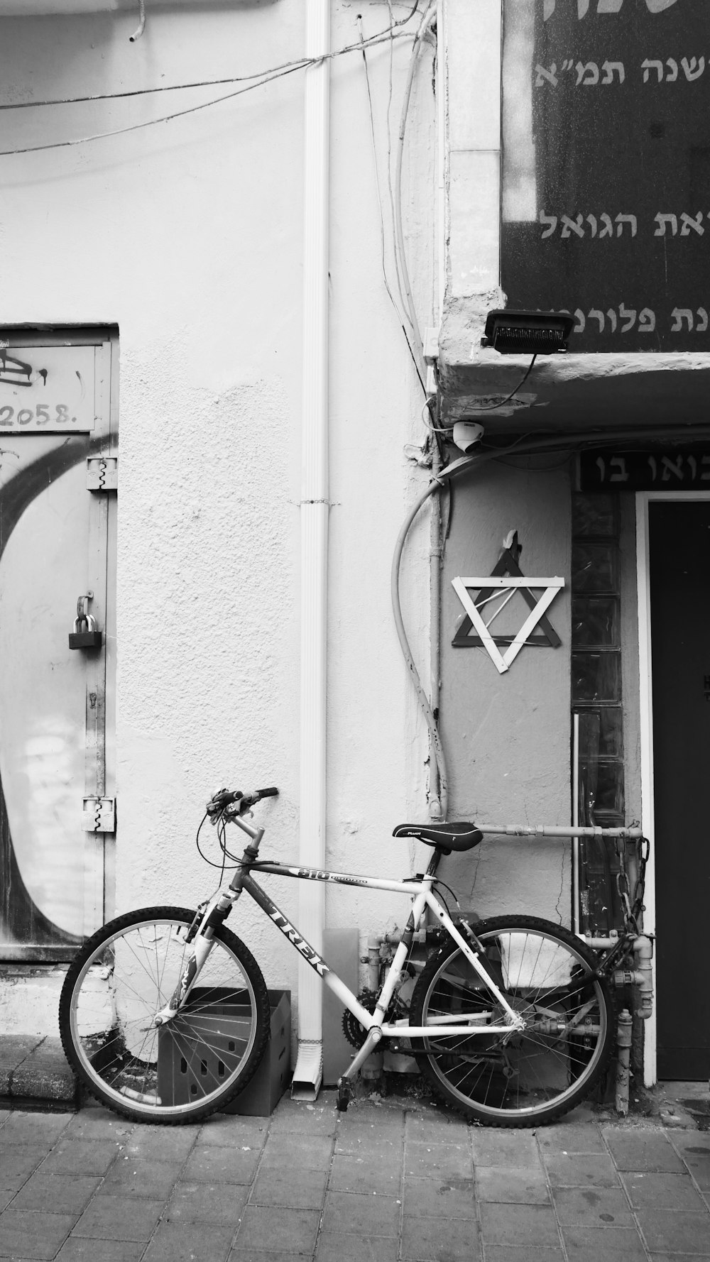 a bike parked next to a building with graffiti on it