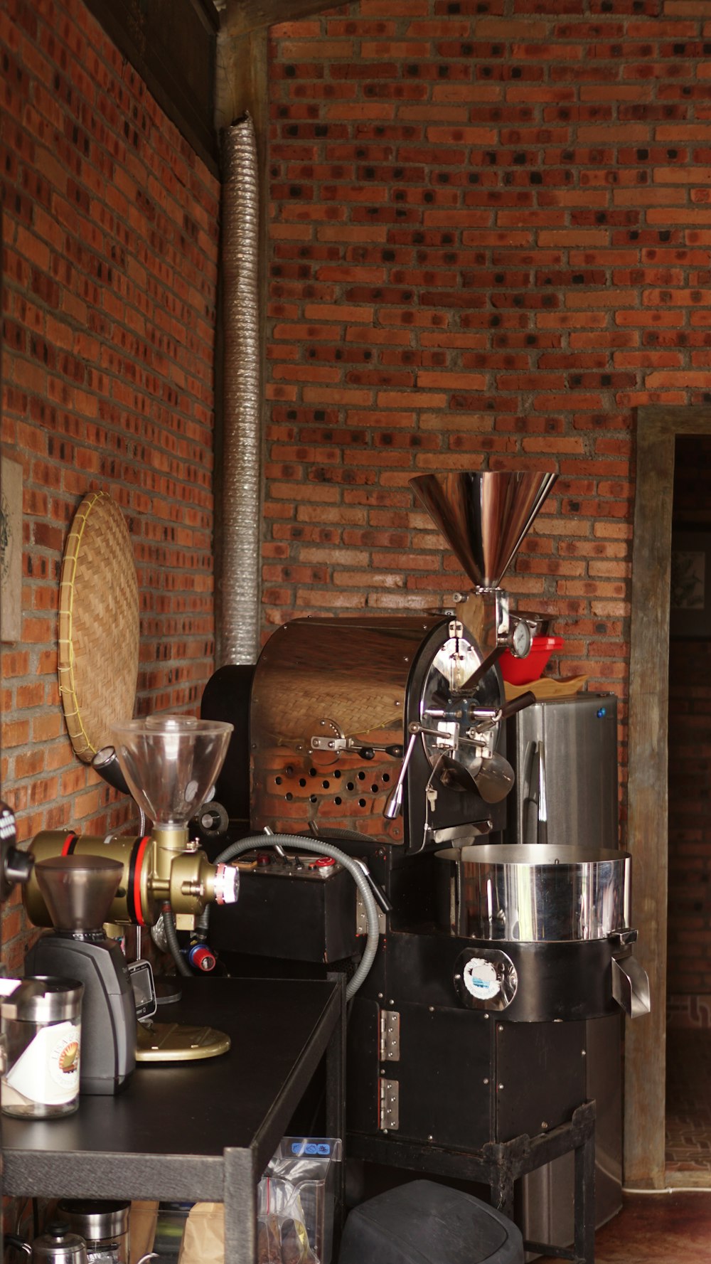 a room with a brick wall and a coffee maker