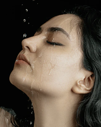 a woman with green hair is taking a shower