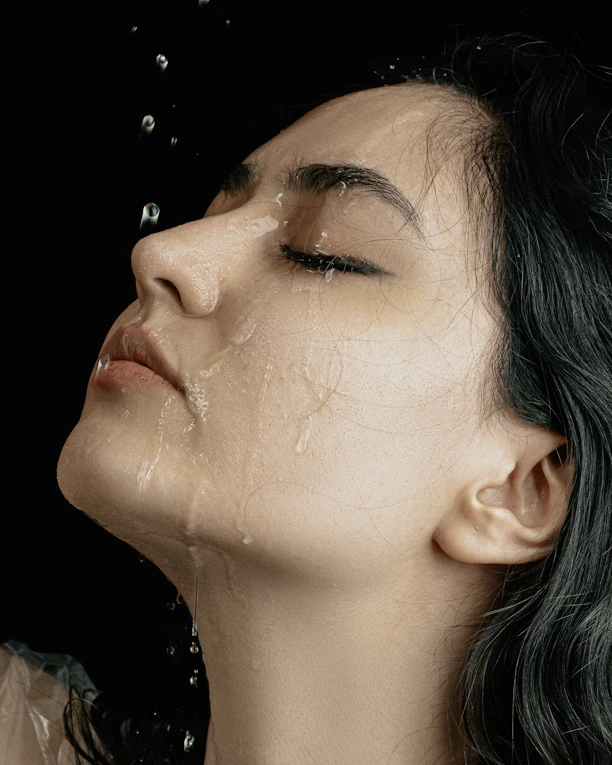a woman with green hair is taking a shower