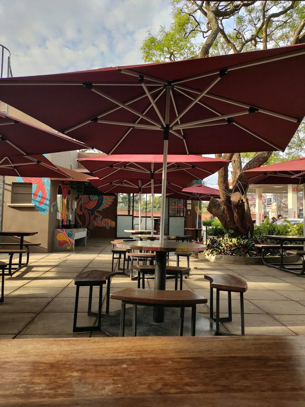 a group of tables with umbrellas over them