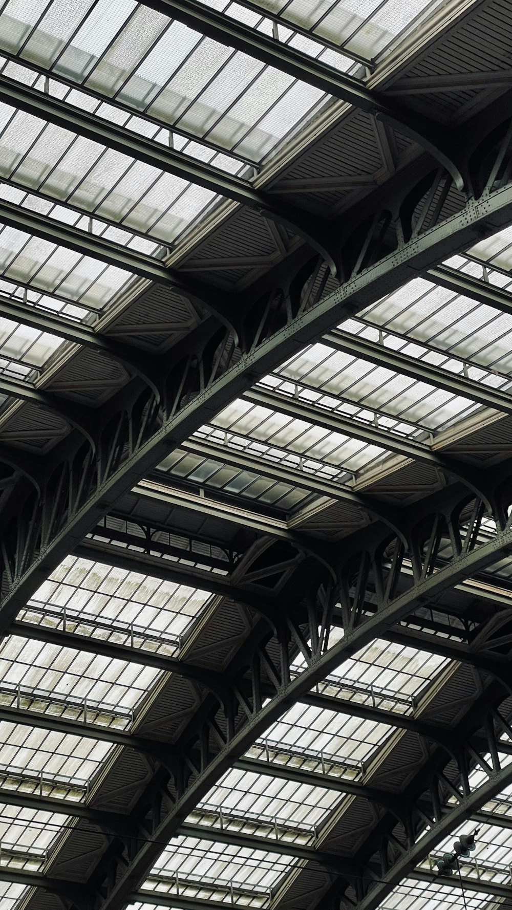 a train station with lots of windows and a clock