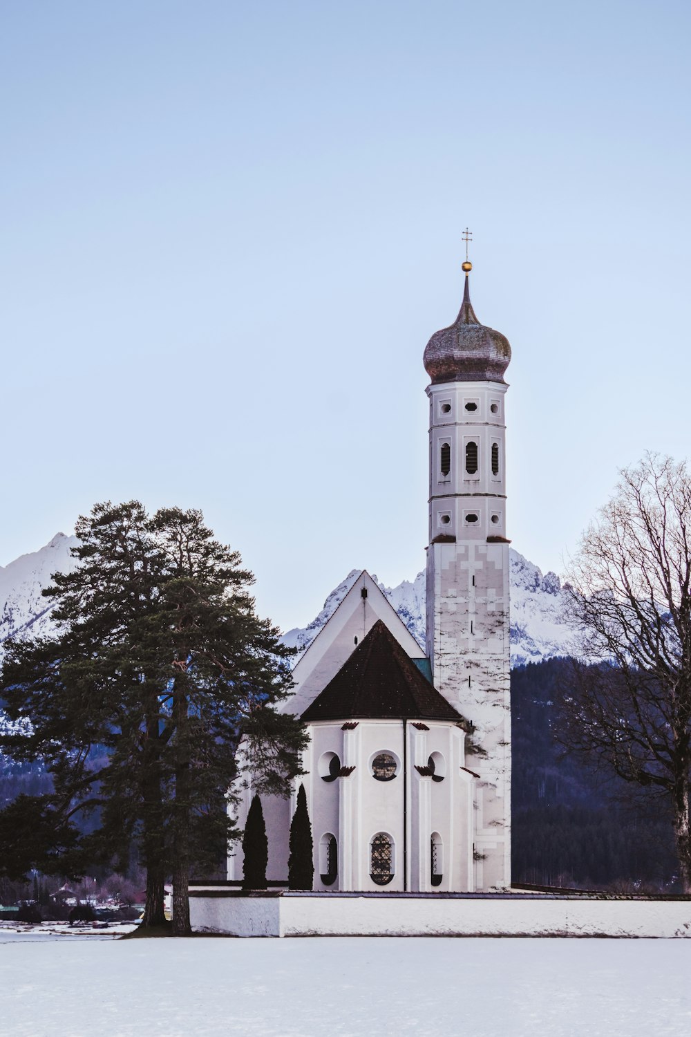 a church in the middle of a snowy field