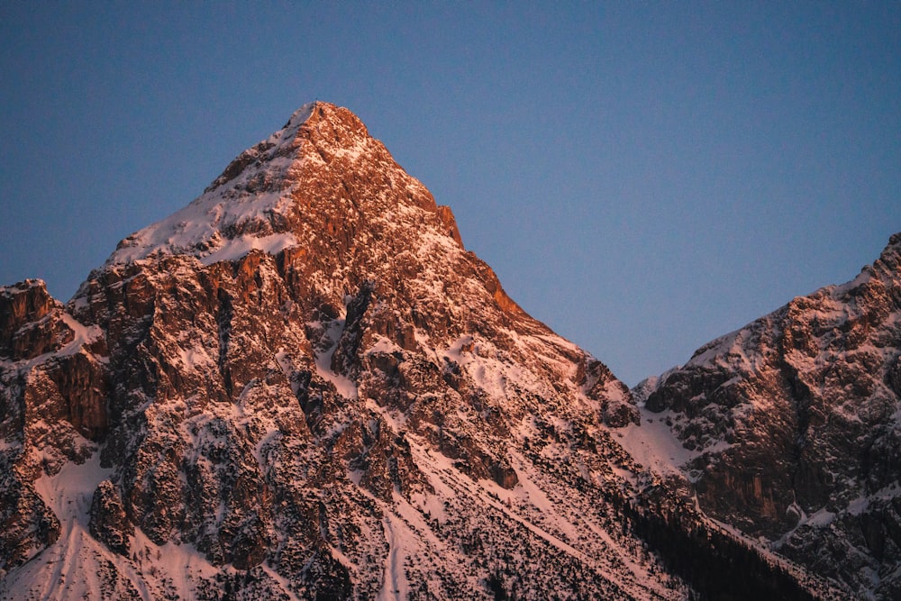 a snow covered mountain with a blue sky in the background