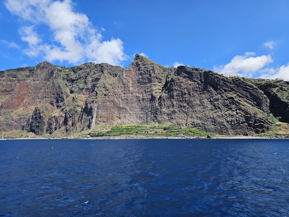 a large mountain rising above a body of water