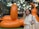 a woman is standing in front of an orange balloon