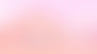 a blurry image of a pink and white background