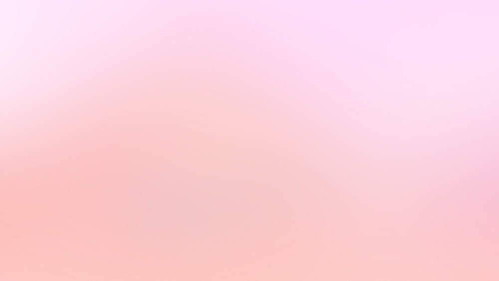 una imagen borrosa de un fondo rosa y blanco