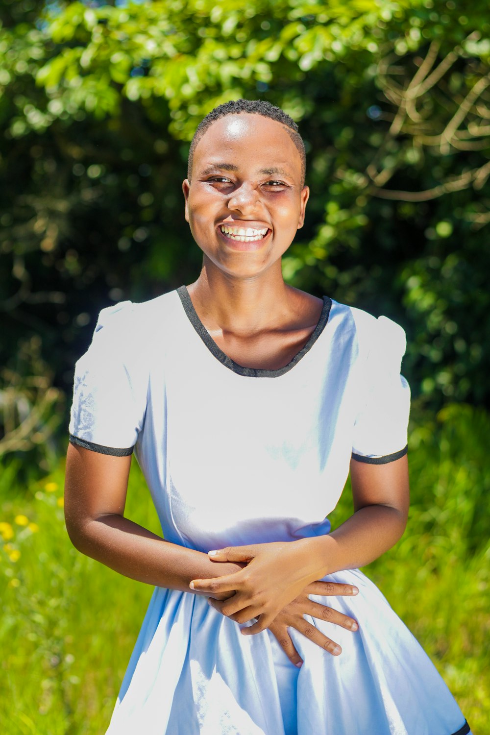 a woman in a blue and white dress smiles at the camera