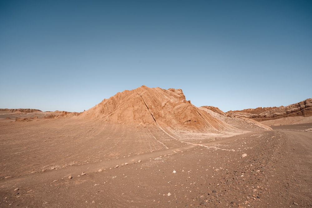 a large pile of dirt in the middle of a desert