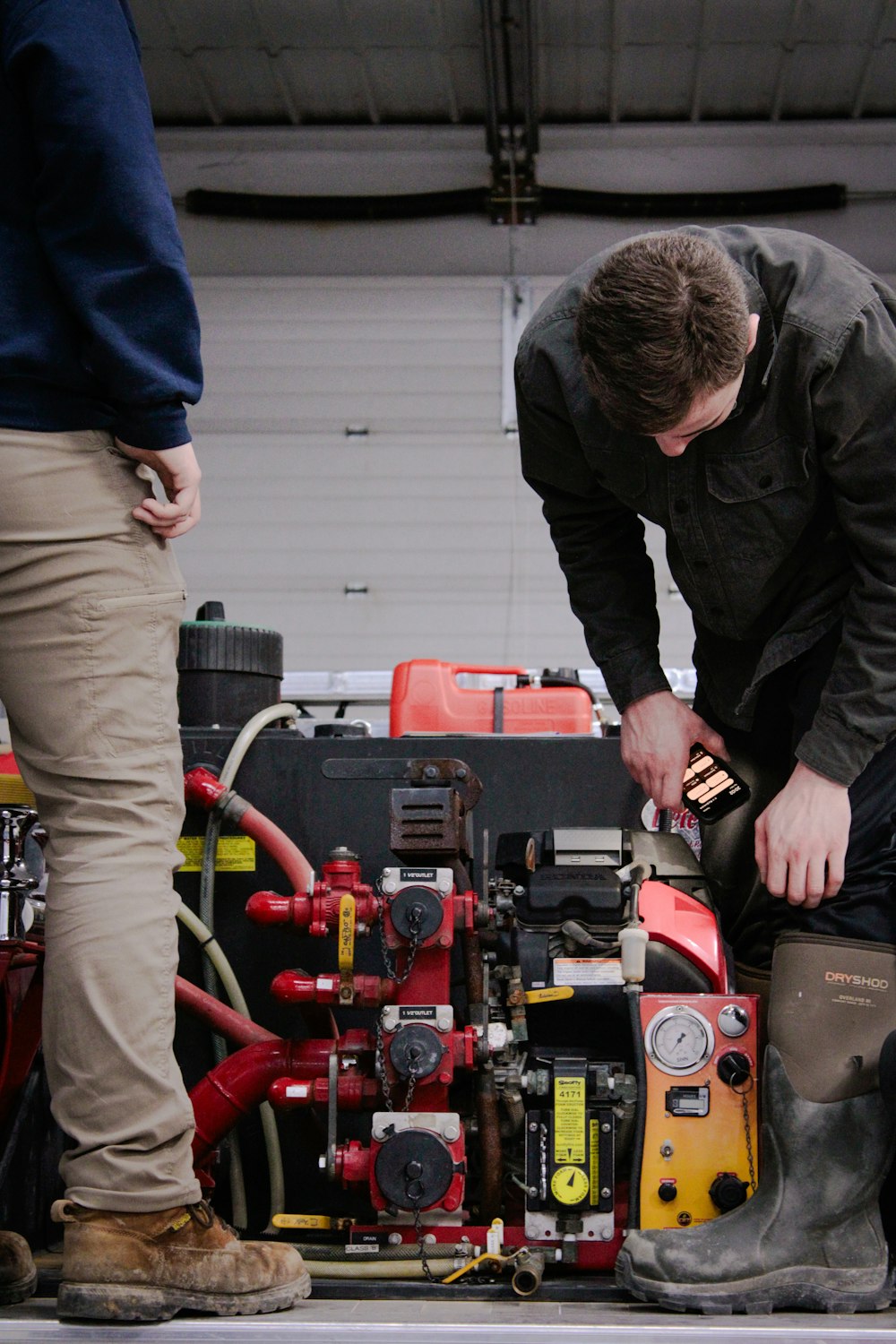 a man working on a machine in a garage