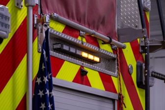 a fire truck with its lights on and american flags