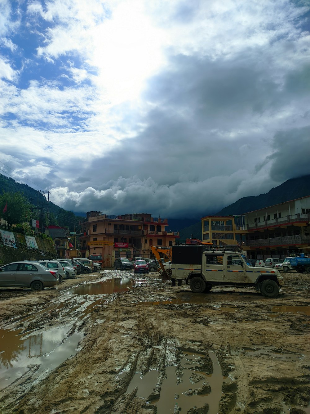 a truck is parked in a muddy parking lot