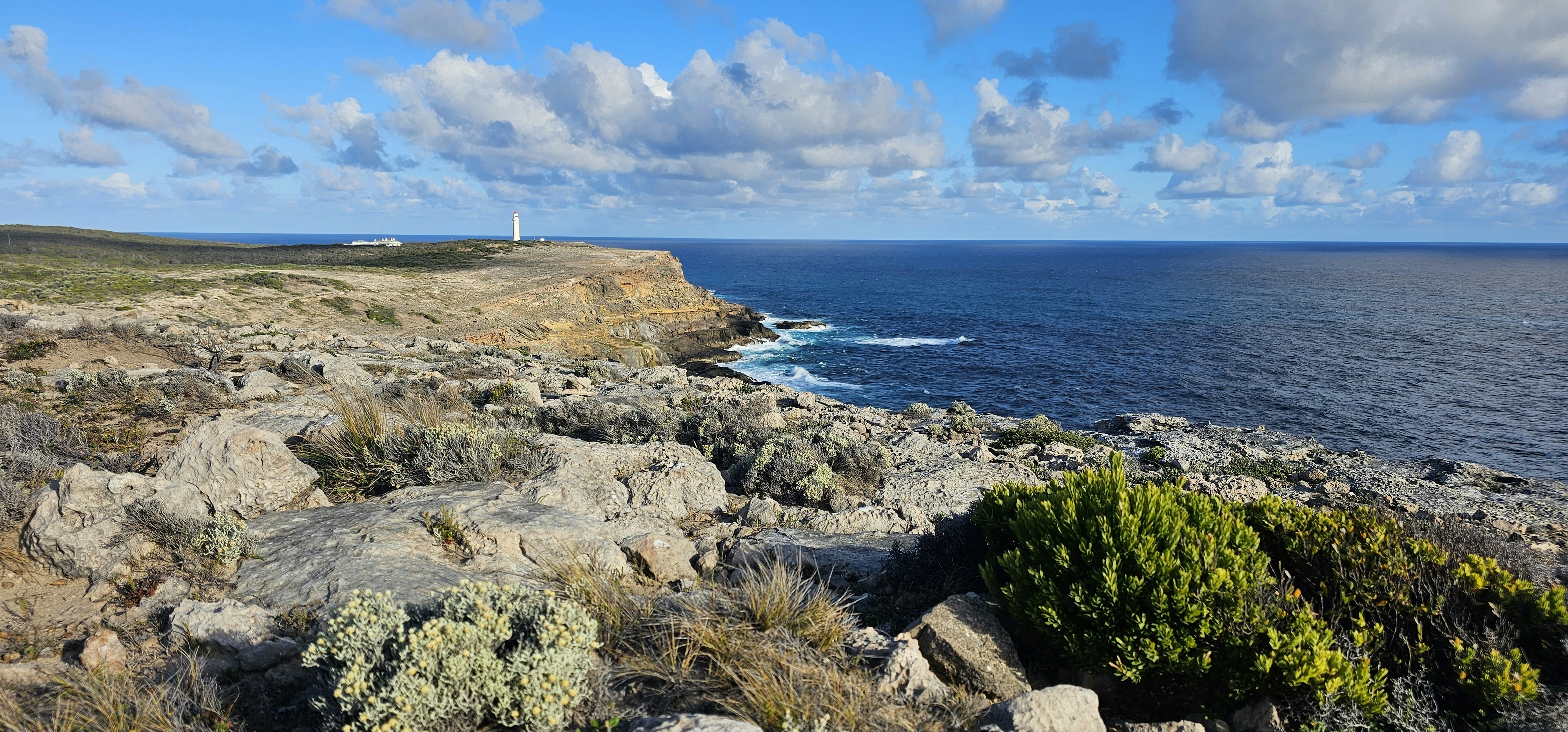 a view of the ocean from a rocky cliff