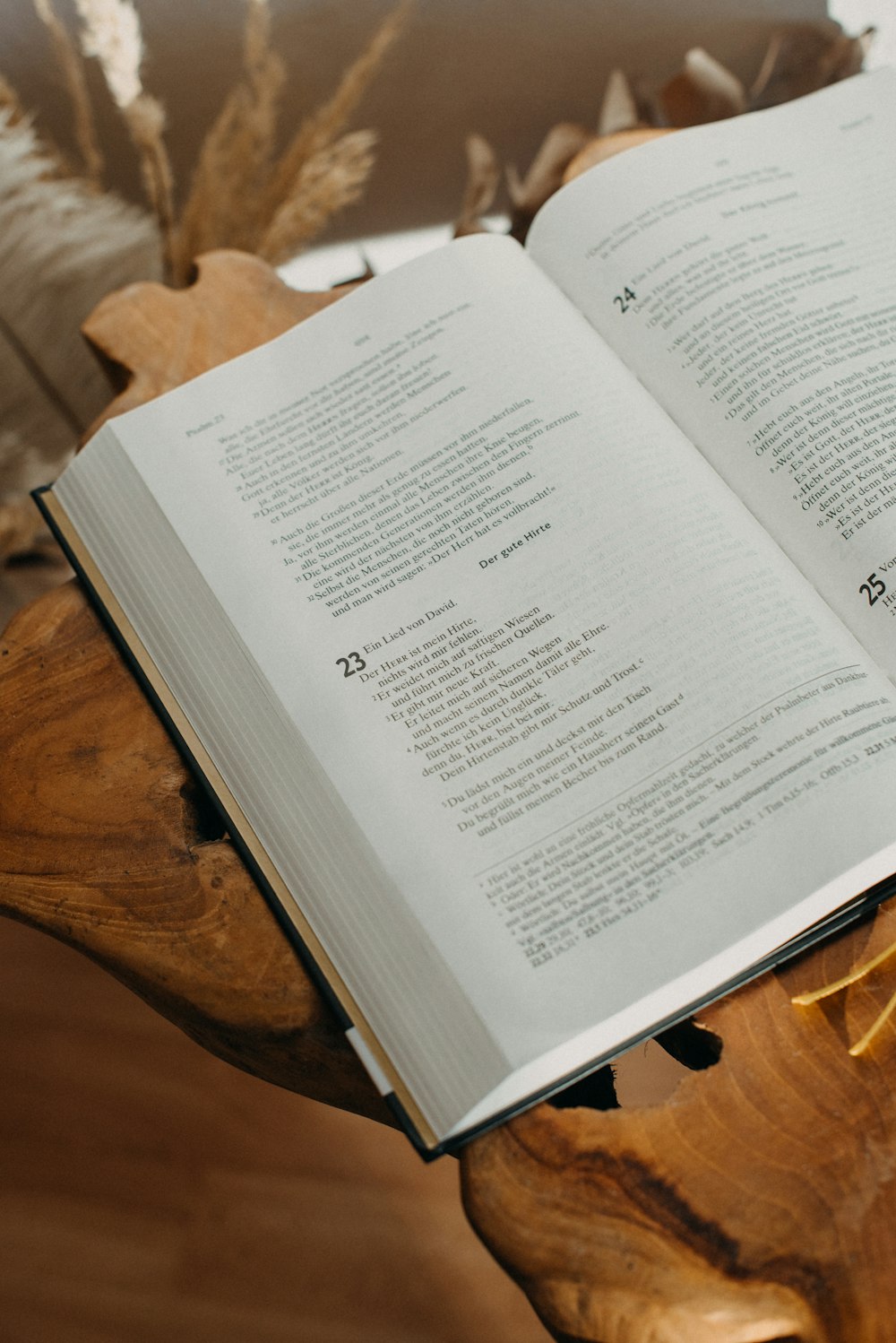 an open book sitting on top of a wooden table