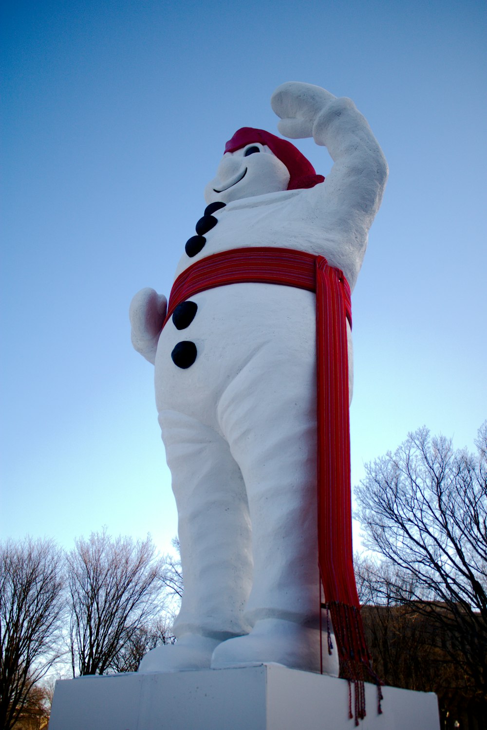 a statue of a snowman with a red scarf around his neck