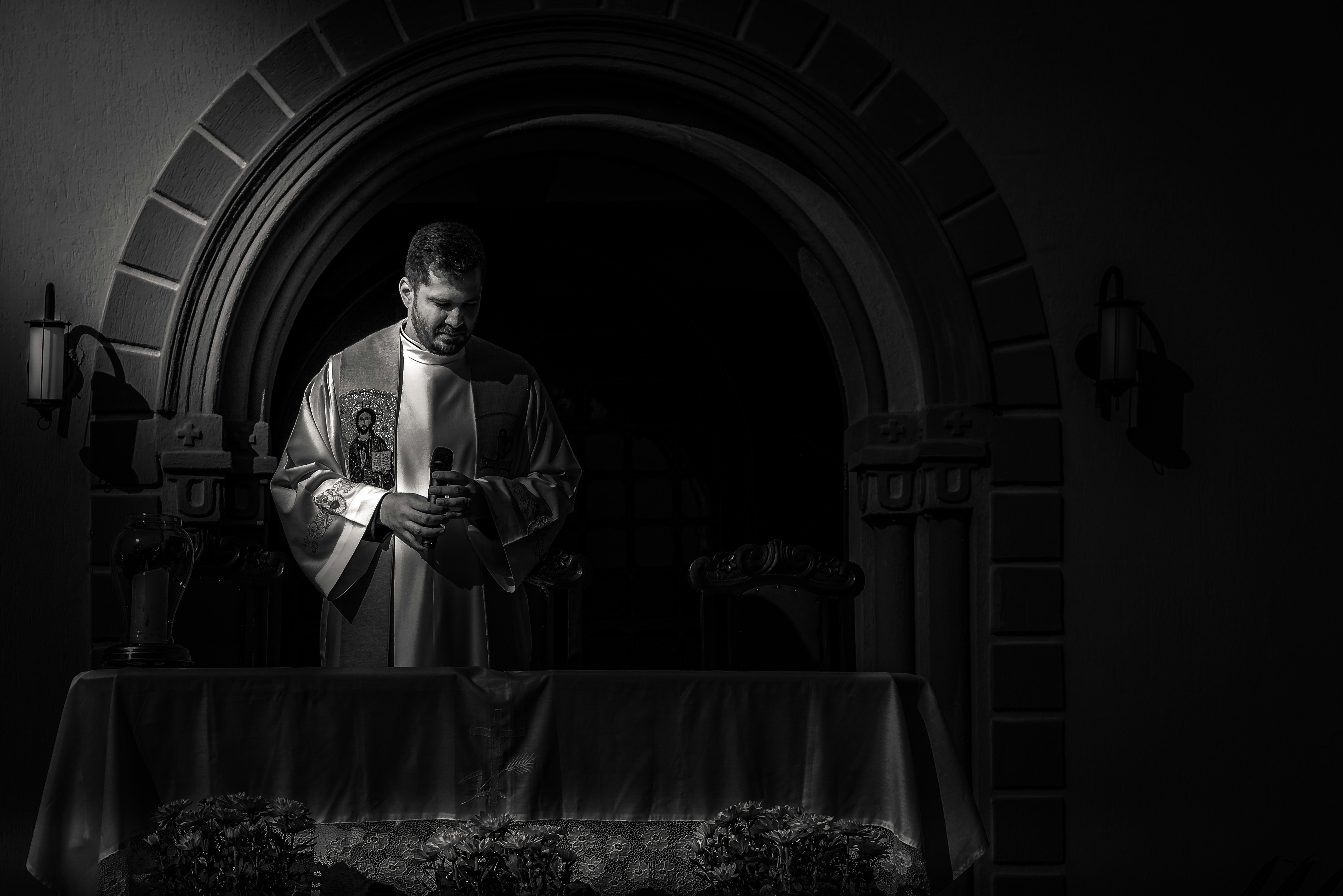 a black and white photo of a priest