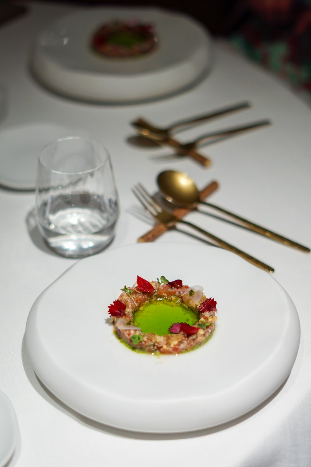 a white table topped with plates and silverware