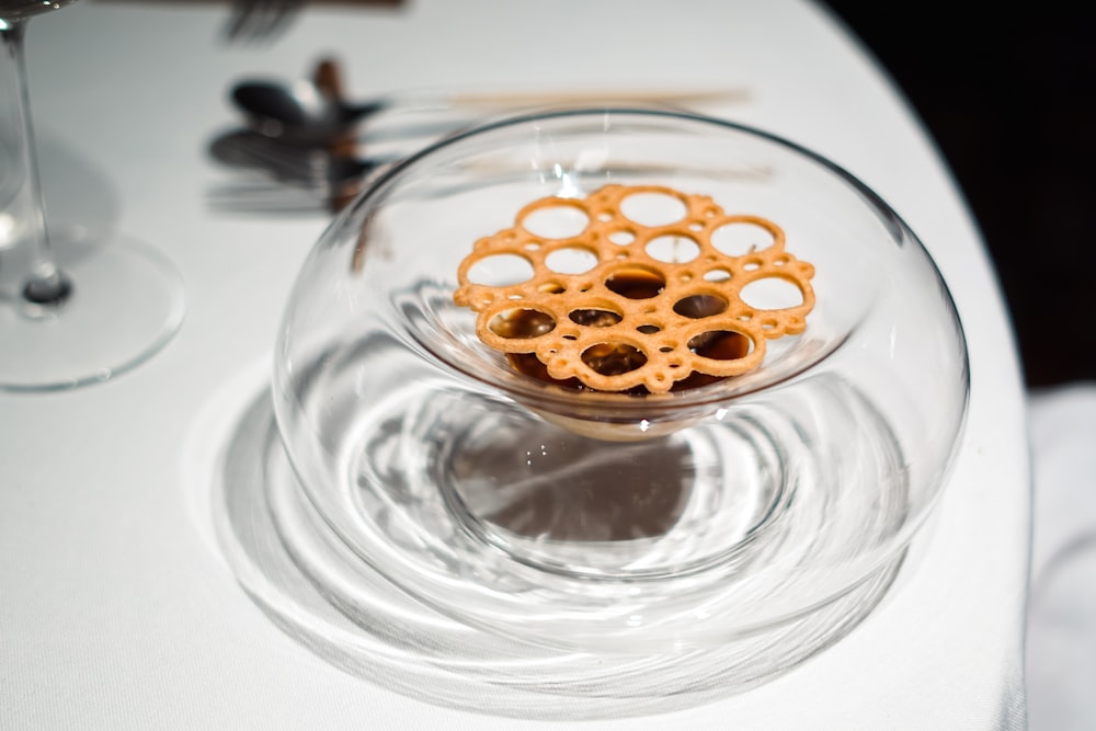 a glass bowl filled with food on top of a table