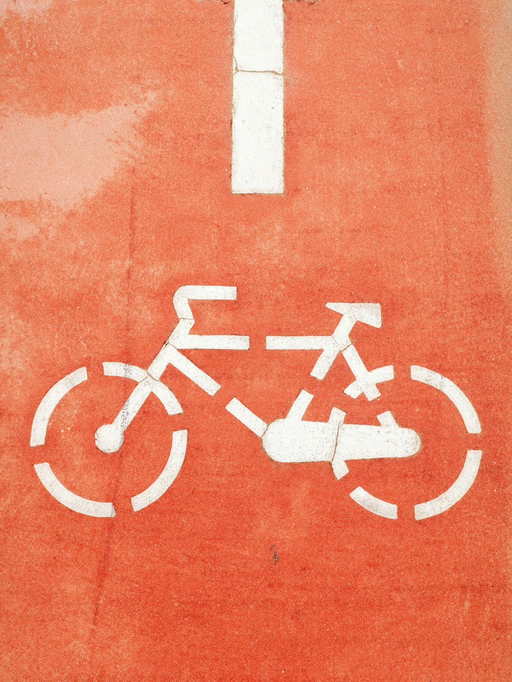 a bicycle sign painted on the side of a building