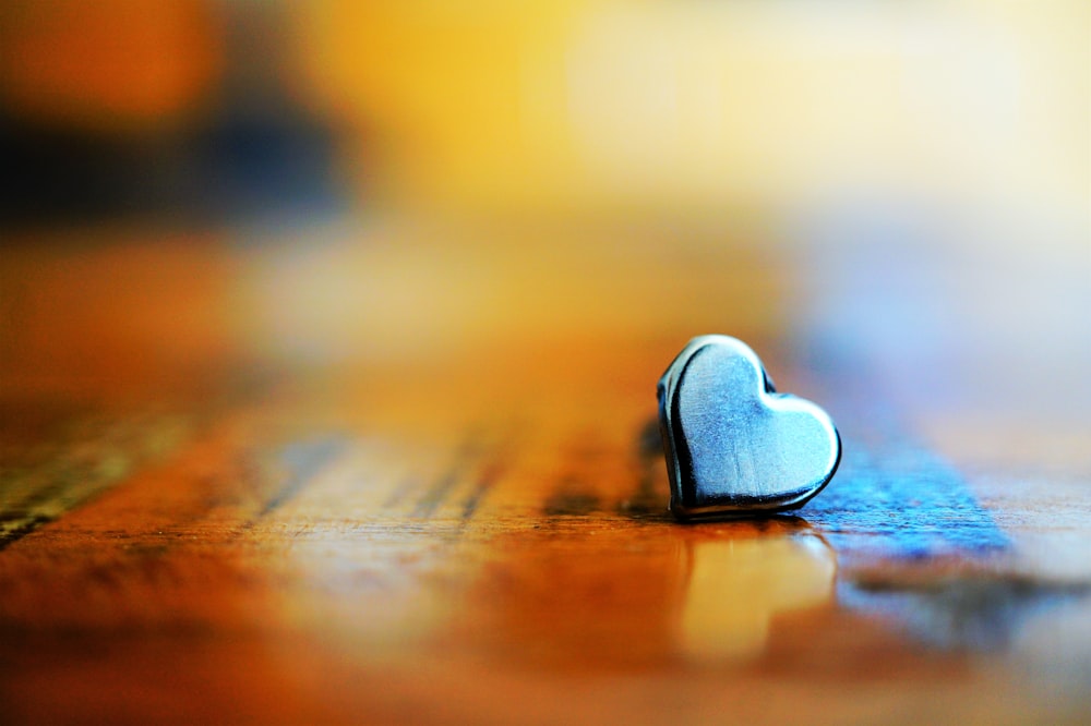 a heart shaped object sitting on top of a wooden floor